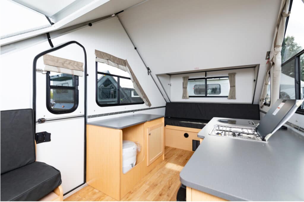 The interior of an rv with a stove and sink.