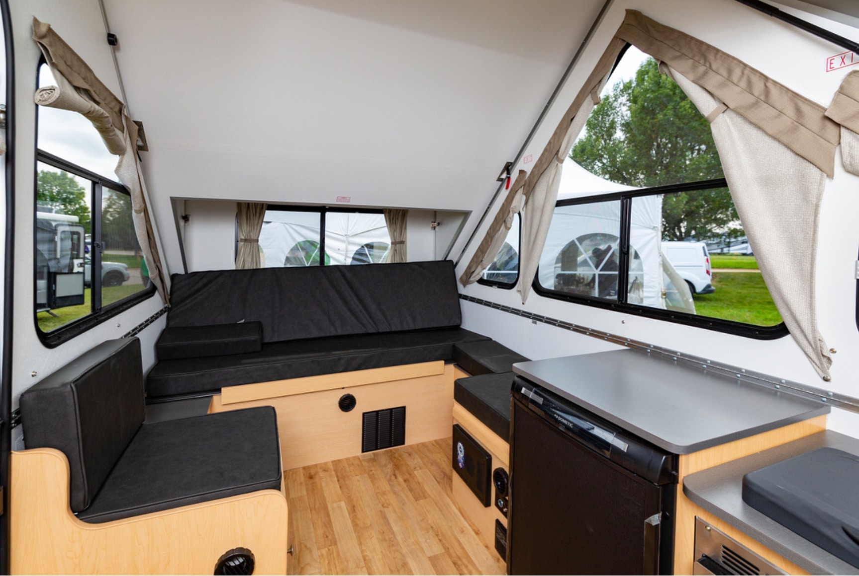 The interior of an rv with a couch and table.