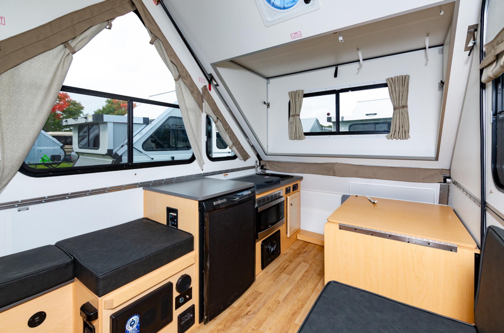 The interior of an rv with a kitchen and dining area.