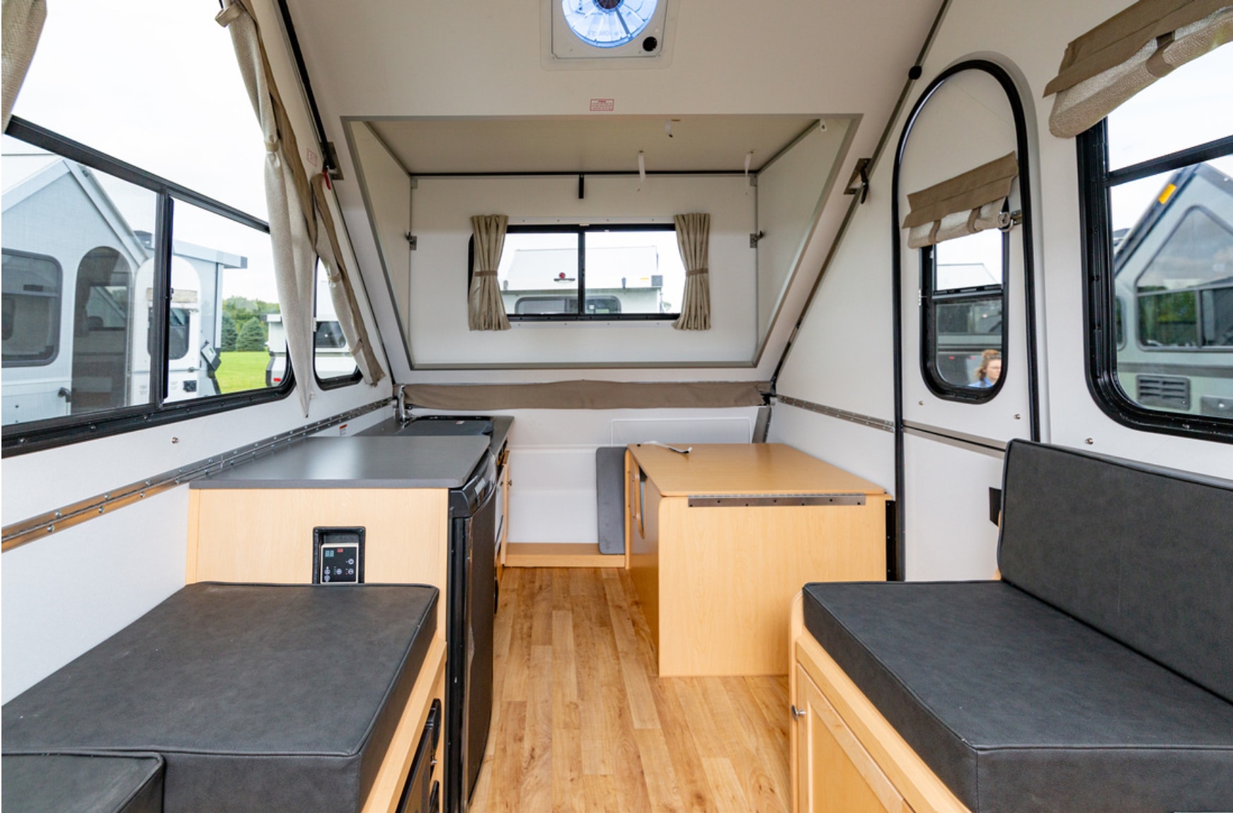 The interior of an rv with a table and chairs.