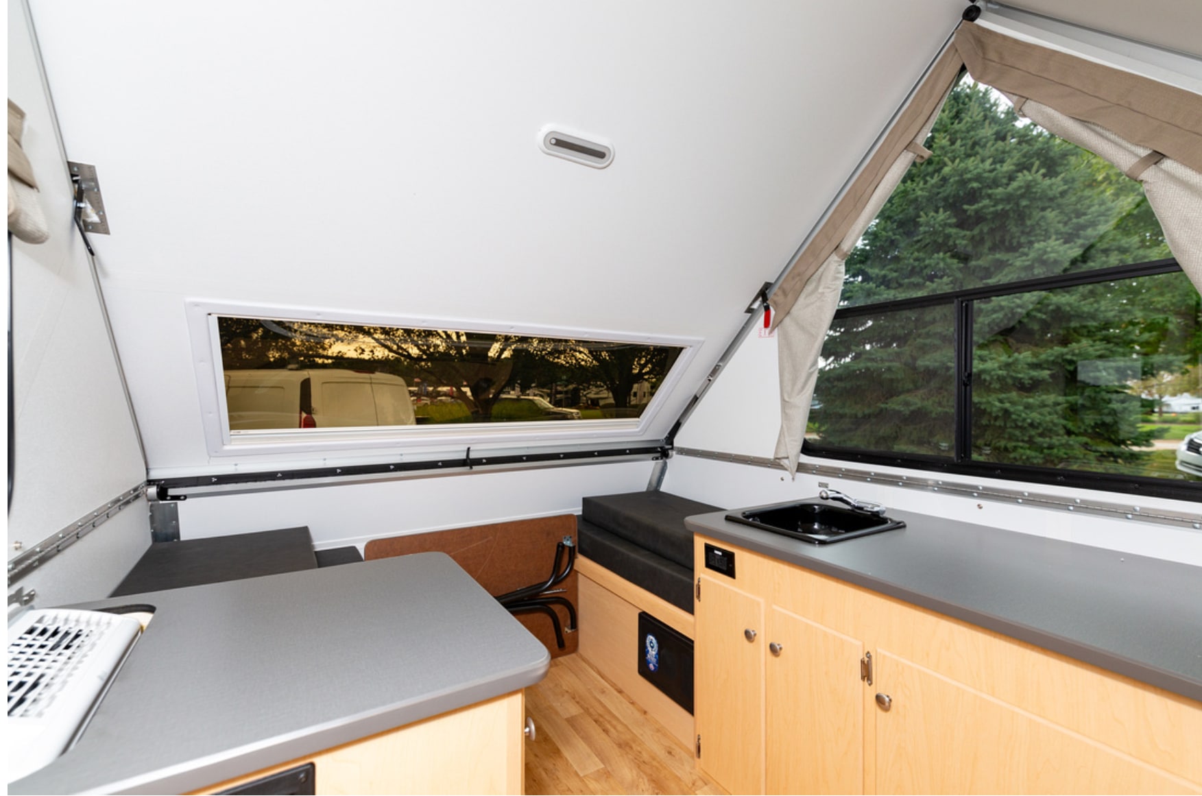 A small kitchen in a campervan with a window.