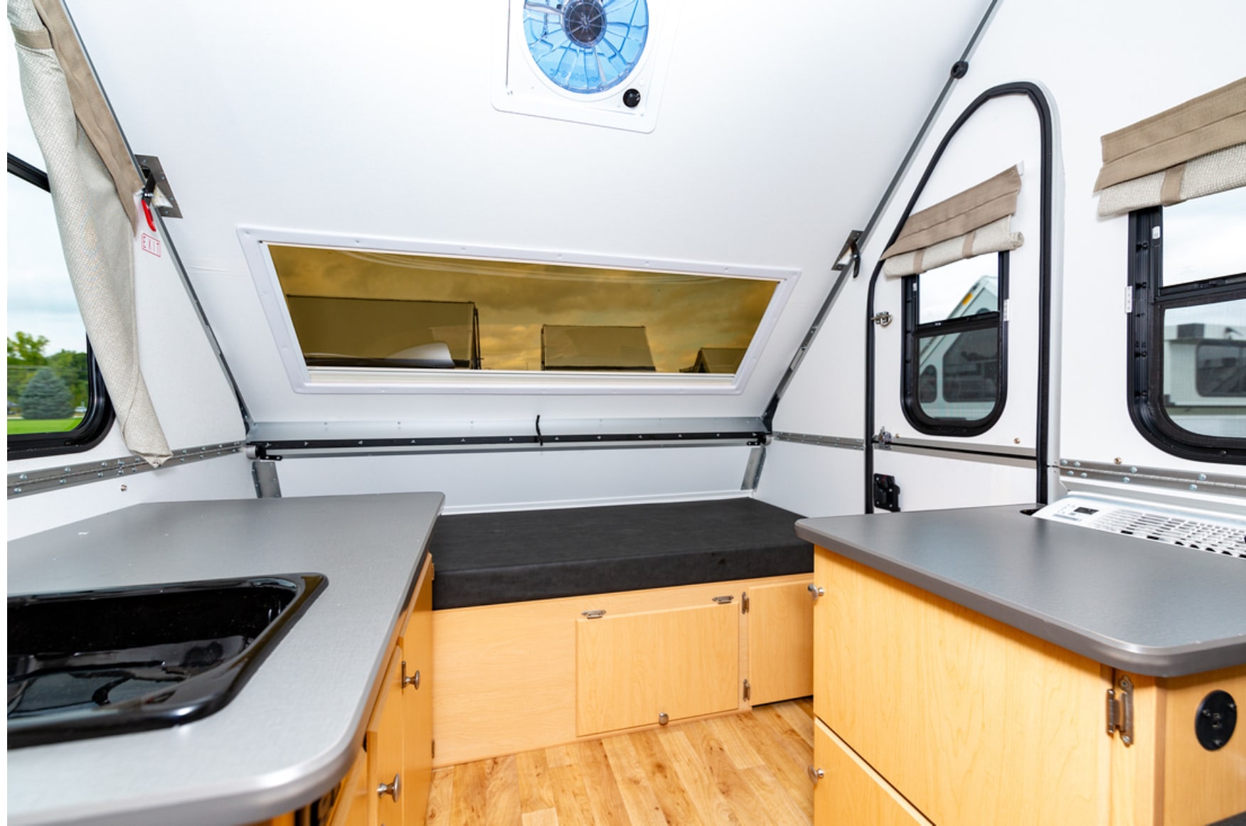 The interior of an rv with a stove and sink.