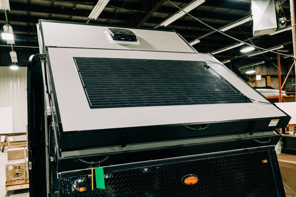 A large truck with a solar panel on the top.