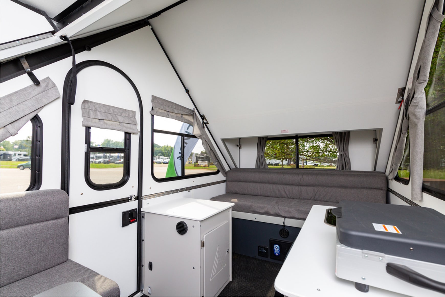 The interior of an rv with a couch and tv.