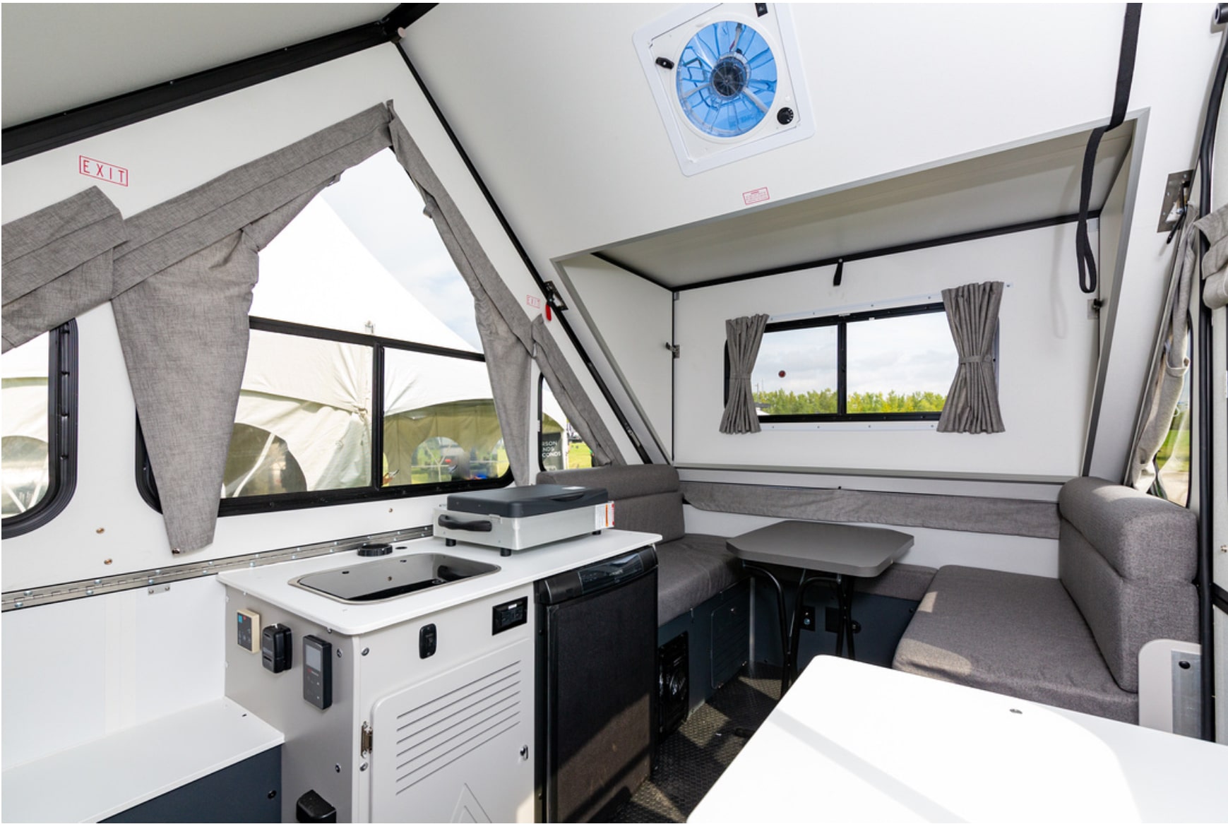 The interior of an rv with a kitchen and dining area.