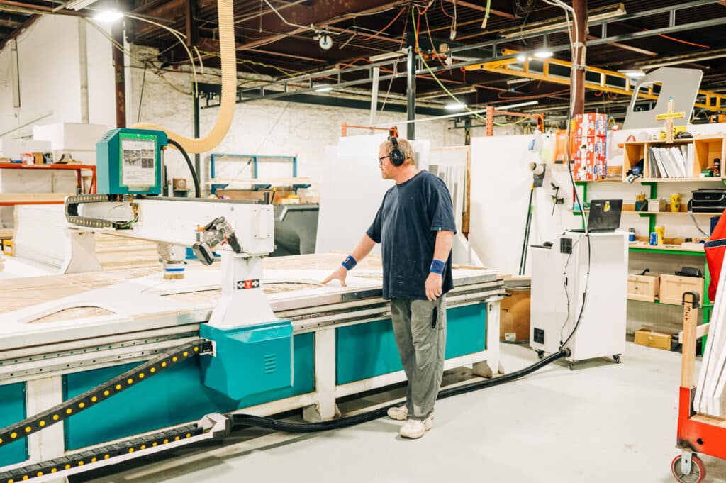 A man standing in front of a machine.