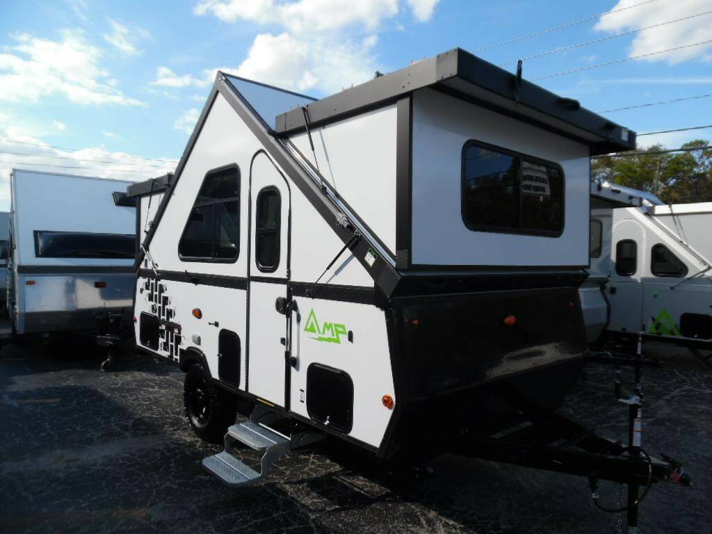 A-frame pop-up camper trailer parked outdoors.