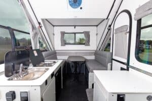 The interior of an rv with a kitchen and dining area.