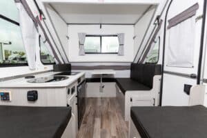 The interior of an rv with a stove and sink.