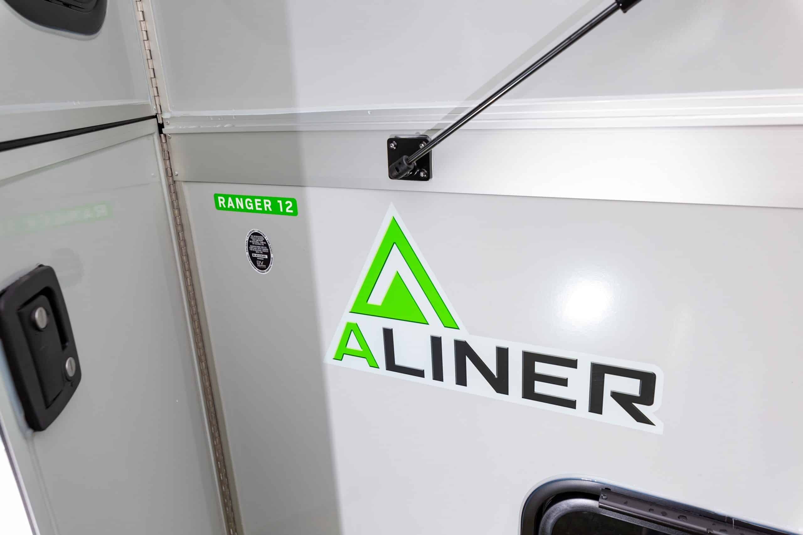 A white camper trailer on a gray background.