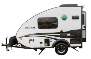 A parked travel trailer with "the grand ascape" branding.